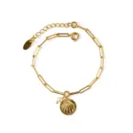 Vintage Shell & Pearl Bracelet 1 LIVKE’s gold shell and pearl bracelet styled on a wrist with a linen sleeve for coastal everyday elegance.