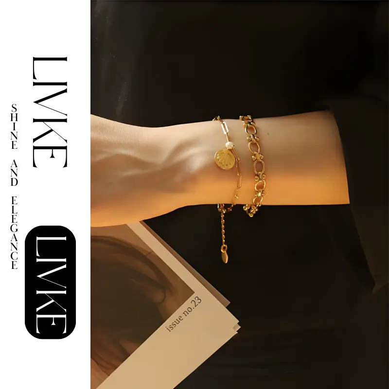 LIVKE’s gold shell and pearl bracelet styled on a wrist with a linen sleeve for coastal everyday elegance.