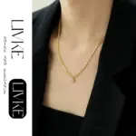 Vintage Square Zircon Pendant Necklace 3 LIVKE’s gold-plated square zircon pendant necklace styled with a white silk blouse for timeless elegance.