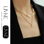 Vintage Square Zircon Pendant Necklace 2 LIVKE’s gold-plated square zircon pendant necklace styled with a white silk blouse for timeless elegance.