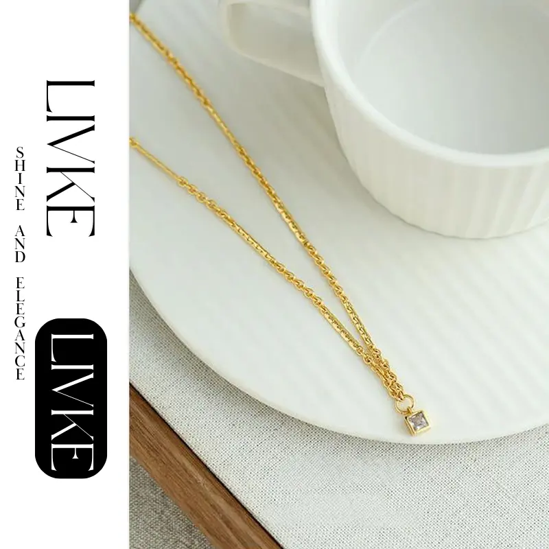 livke-vintage-square-zircon-necklace LIVKE’s gold-plated square zircon pendant necklace styled with a white silk blouse for timeless elegance.