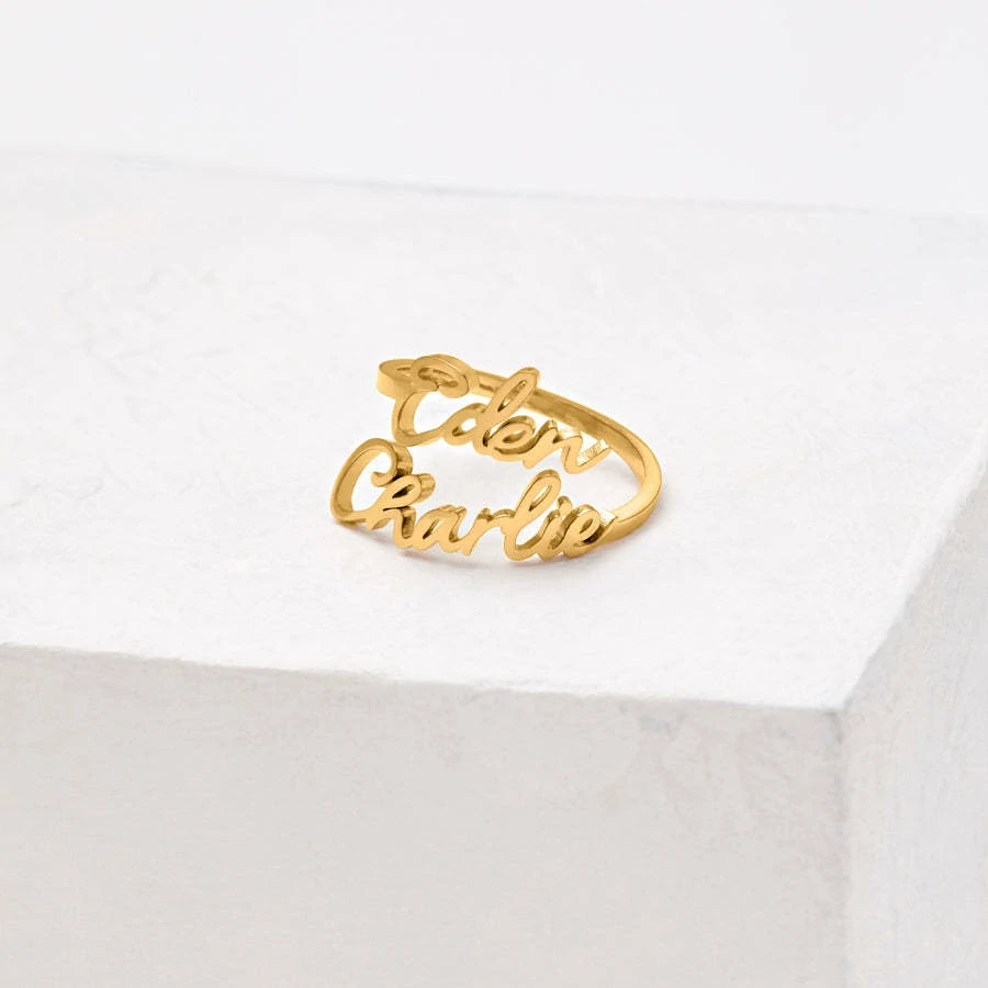 Personalized open-ended couple rings with engraved names "Alex & Sam" in 18K gold.