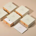 Jewelry Care Set 6 Beige drawer box open with polishing cloth, necklace and ring on velvet background