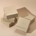 Jewelry Care Set 8 Beige drawer box open with polishing cloth, necklace and ring on velvet background