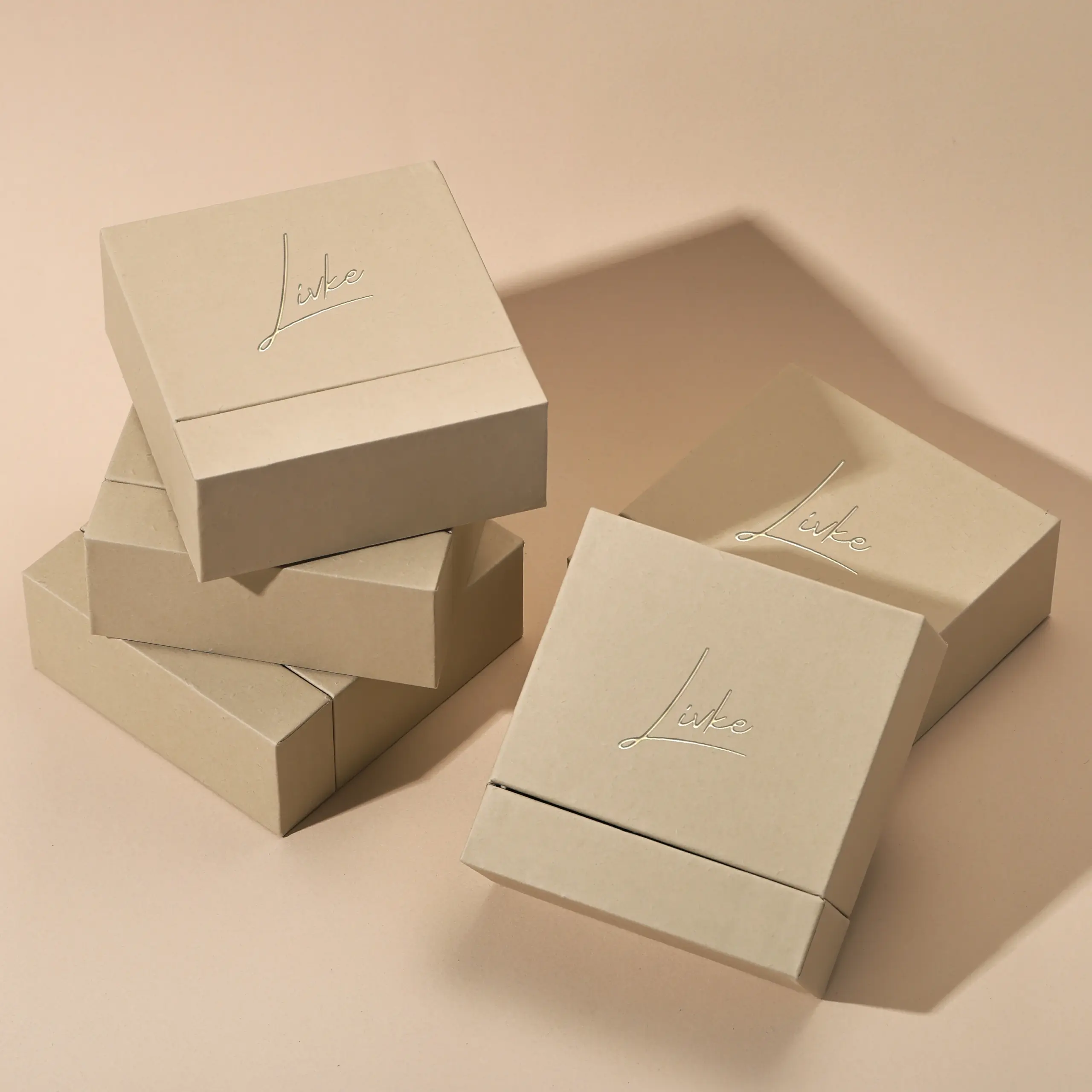 Beige drawer box open with polishing cloth, necklace and ring on velvet background