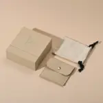 Jewelry Care Set 7 Beige drawer box open with polishing cloth, necklace and ring on velvet background