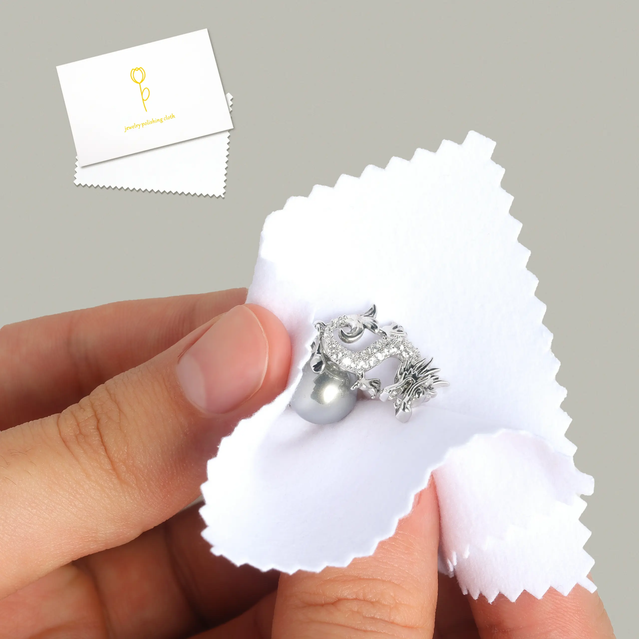 Close-up of a microfiber jewelry polishing cloth showing textured and smooth sides