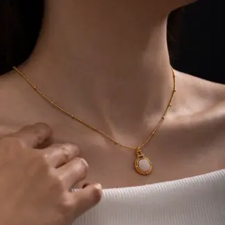 Woman wearing LIVKE vintage cubic zirconia necklace with turtleneck and trench coat, showcasing minimalist retro jewelry for urban elegance