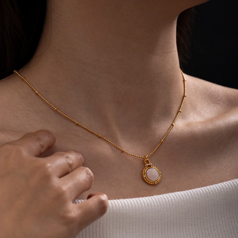 Woman wearing LIVKE vintage cubic zirconia necklace with turtleneck and trench coat, showcasing minimalist retro jewelry for urban elegance