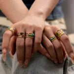 18K Gold-Plated Three-Layer Winding Ring 8 Hand wearing LIVKE triple-layered titanium ring with natural stone inlay during business meeting and cocktail party, showcasing versatile power jewelry