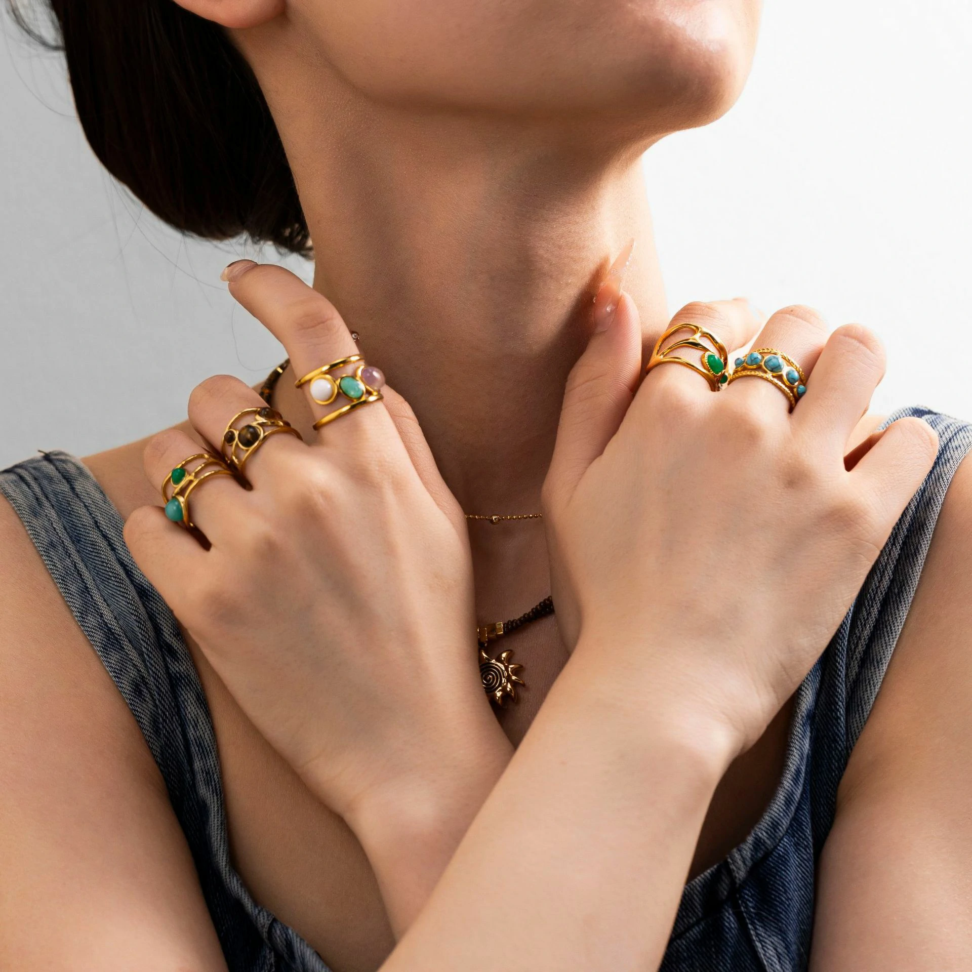 Hand wearing LIVKE triple-layered titanium ring with natural stone inlay during business meeting and cocktail party, showcasing versatile power jewelry