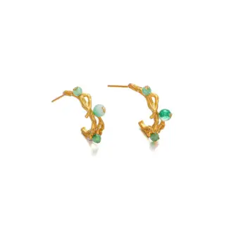 Woman wearing LIVKE gold vine earrings with green gemstones at outdoor garden party, showcasing organic luxury jewelry