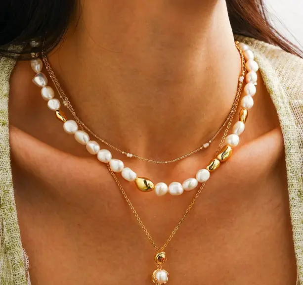 Young woman wearing LIVKE bohemian pearl choker necklace with floral dress in sunflower field, showcasing cottagecore aesthetic jewelry