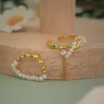 Adjustable Pearl Tassel Ring 3 Hand wearing LIVKE adjustable pearl tassel ring at desert festival, showcasing boho jewelry with flowing movement