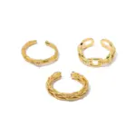 Braided Gold Rings – Geometric Hollow Design 1 Stacked LIVKE braided and chain rings on hand with bohemian embroidery sleeve, showcasing boho-chic layering.