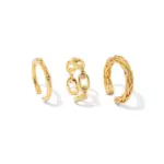 Braided Gold Rings – Geometric Hollow Design 6 Stacked LIVKE braided and chain rings on hand with bohemian embroidery sleeve, showcasing boho-chic layering.