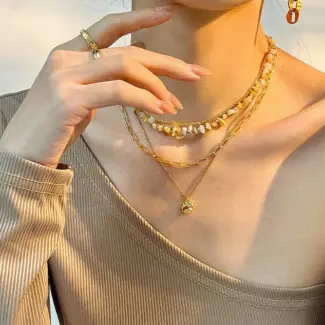 Woman wearing LIVKE cat and shell necklace walking with cat on sunset beach, symbolizing pet love and coastal aesthetic jewelry