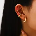 Love Frequency Earrings 2 18K gold-plated adjustable heart ring with brilliant zirconia center, layered with minimalist bands on marble texture