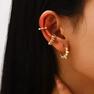 18K gold-plated adjustable heart ring with brilliant zirconia center, layered with minimalist bands on marble texture