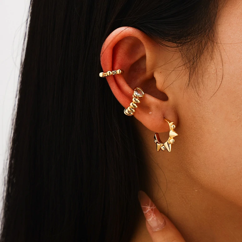 livke-eternal-pulse-heart-ring-stackable (4) 18K gold-plated adjustable heart ring with brilliant zirconia center, layered with minimalist bands on marble texture