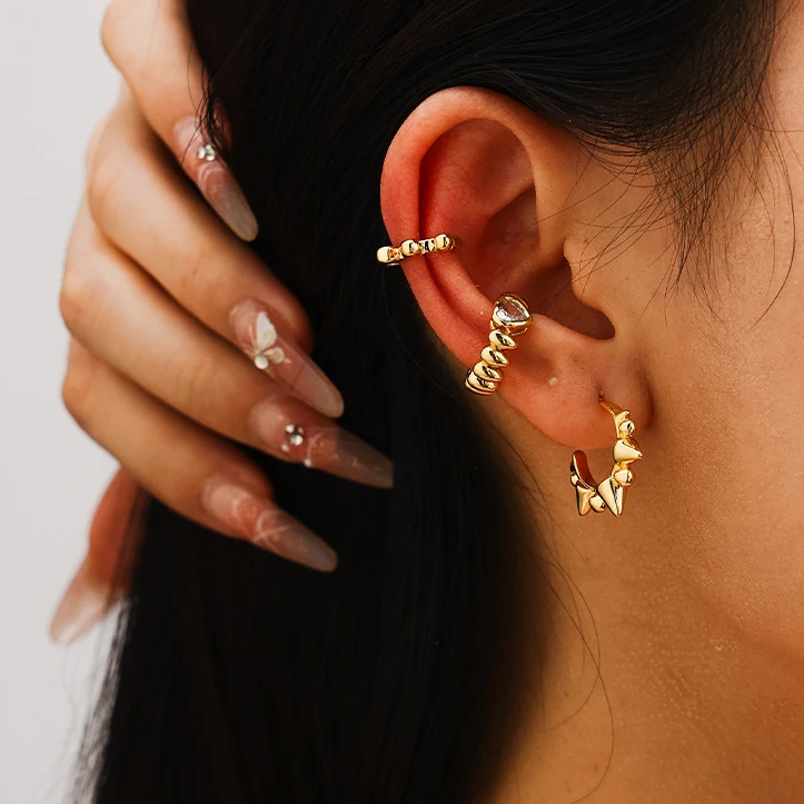 livke-eternal-pulse-heart-ring-stackable (5) 18K gold-plated adjustable heart ring with brilliant zirconia center, layered with minimalist bands on marble texture