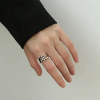 Architect wearing LIVKE geometric ring with concrete maquette in Berlin gallery, demonstrating jewelry as micro-architecture