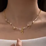18K Gold Cross Pendant Necklace 2 Young woman wearing LIVKE gold cross necklace with layered chains at music festival, blending spiritual jewelry with bohemian style