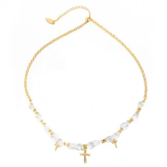 Young woman wearing LIVKE gold cross necklace with layered chains at music festival, blending spiritual jewelry with bohemian style