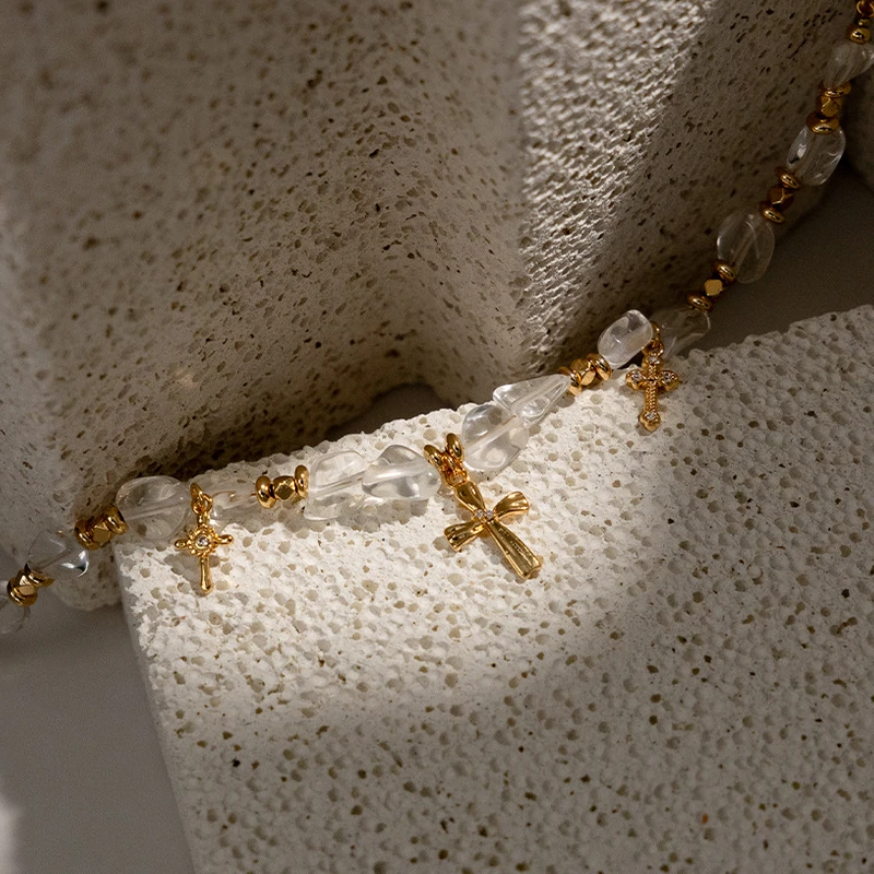 Young woman wearing LIVKE gold cross necklace with layered chains at music festival, blending spiritual jewelry with bohemian style