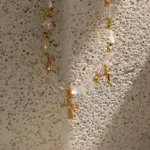 18K Gold Cross Pendant Necklace 4 Young woman wearing LIVKE gold cross necklace with layered chains at music festival, blending spiritual jewelry with bohemian style