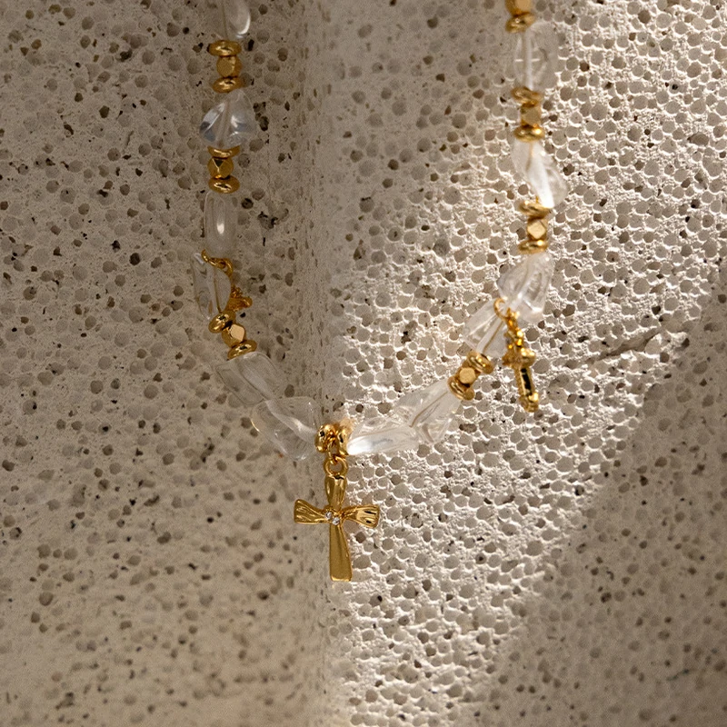 Young woman wearing LIVKE gold cross necklace with layered chains at music festival, blending spiritual jewelry with bohemian style