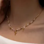 18K Gold Cross Pendant Necklace 3 Young woman wearing LIVKE gold cross necklace with layered chains at music festival, blending spiritual jewelry with bohemian style