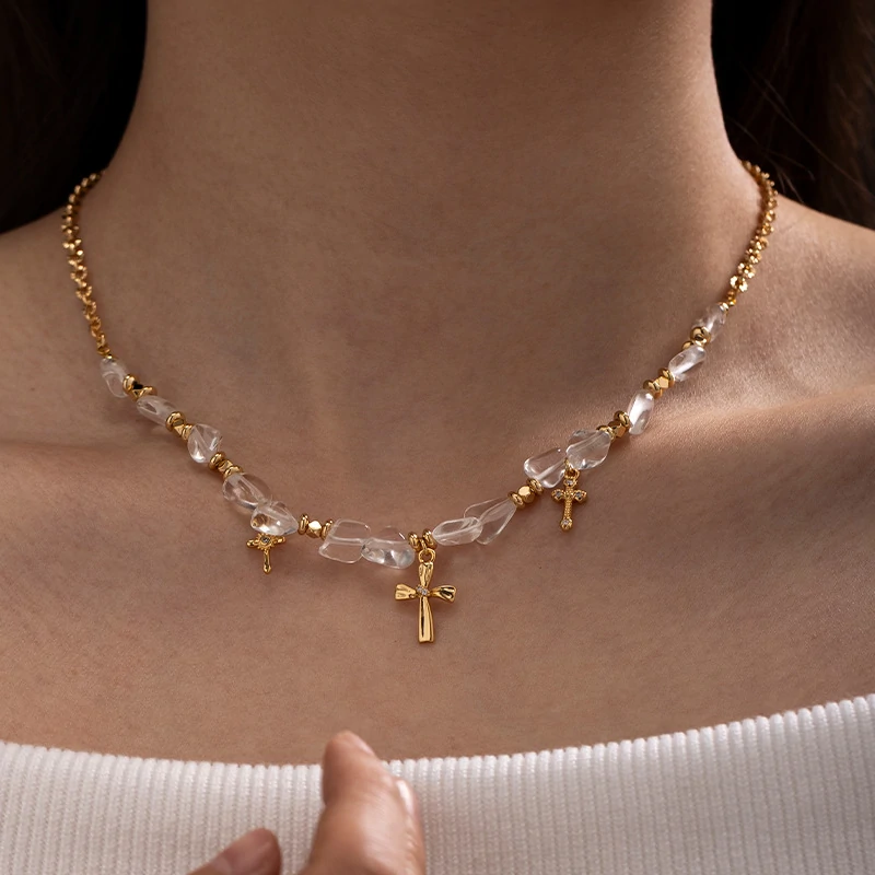Young woman wearing LIVKE gold cross necklace with layered chains at music festival, blending spiritual jewelry with bohemian style