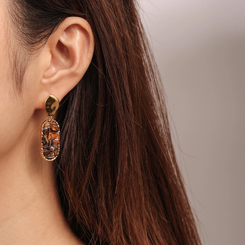 livke-gold-teardrop-earrings-tiger-eye-boho Woman wearing LIVKE teardrop tiger eye earrings with tailored blazer, showcasing minimalist office jewelry with natural stone accents