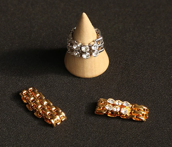 Hand wearing LIVKE gold zircon rings with geometric layout, paired with minimalist bands for urban chic style