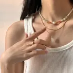 LIVKE Green Aventurine Pendant Necklace 2 Woman wearing LIVKE green aventurine and white jade necklace with cashmere sweater, showcasing minimalist jewelry for urban elegance