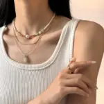 LIVKE Green Aventurine Pendant Necklace 3 Woman wearing LIVKE green aventurine and white jade necklace with cashmere sweater, showcasing minimalist jewelry for urban elegance