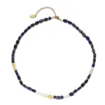 Lapis Lazuli & Gold Beaded Necklace 1 Woman wearing LIVKE lapis lazuli and gold beaded necklace with tailored black dress, showcasing mysterious yet elegant office-to-event jewelry