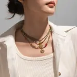 18K Gold Round Beaded Necklace 2 Woman wearing LIVKE cubic zirconia sweater necklace with knitwear and blazer, showcasing versatile minimalist jewelry for work and casual outfits