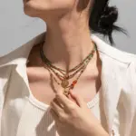 18K Gold Round Beaded Necklace 3 Woman wearing LIVKE cubic zirconia sweater necklace with knitwear and blazer, showcasing versatile minimalist jewelry for work and casual outfits