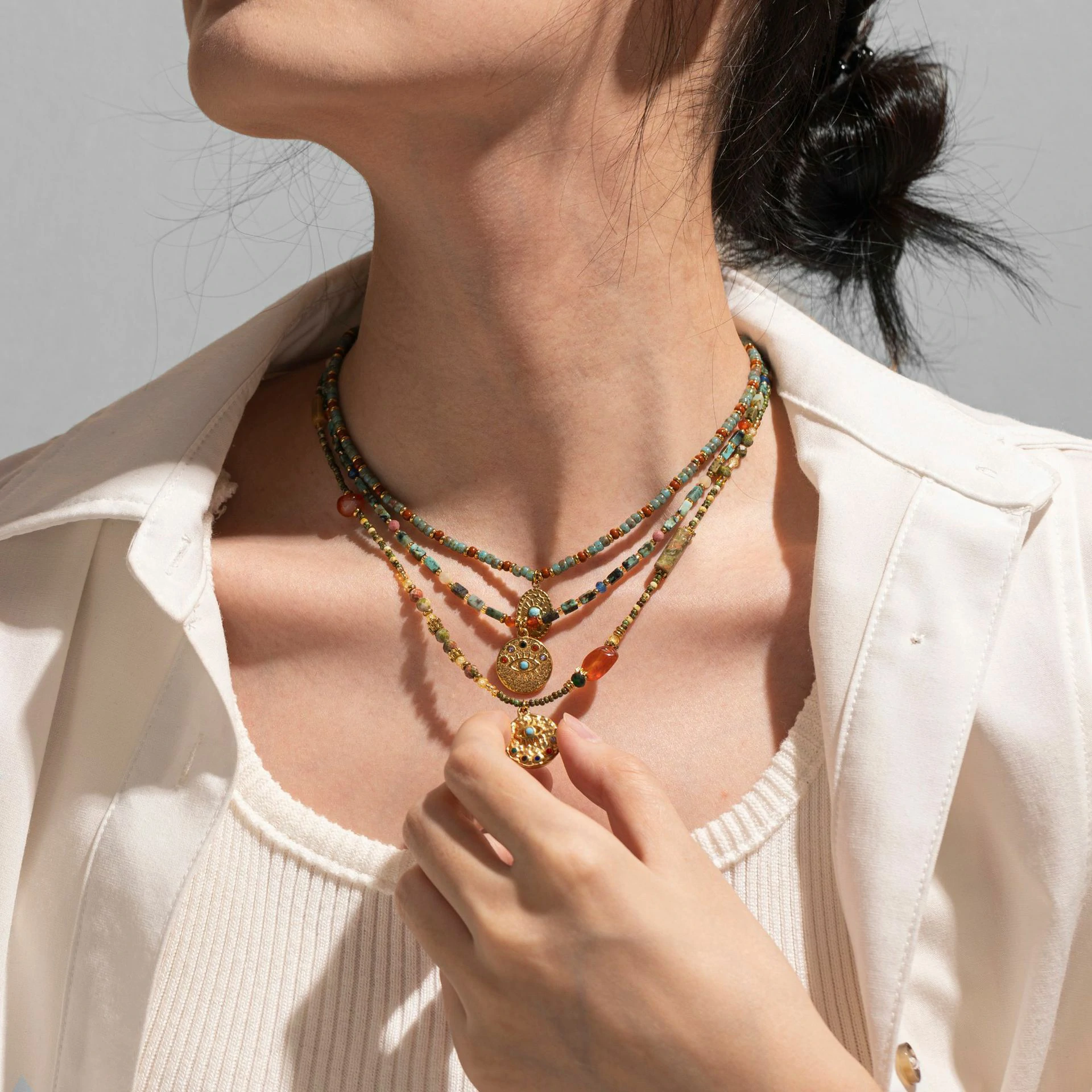 livke-minimalist-zirconia-sweater-necklace-layering (6) Woman wearing LIVKE cubic zirconia sweater necklace with knitwear and blazer, showcasing versatile minimalist jewelry for work and casual outfits