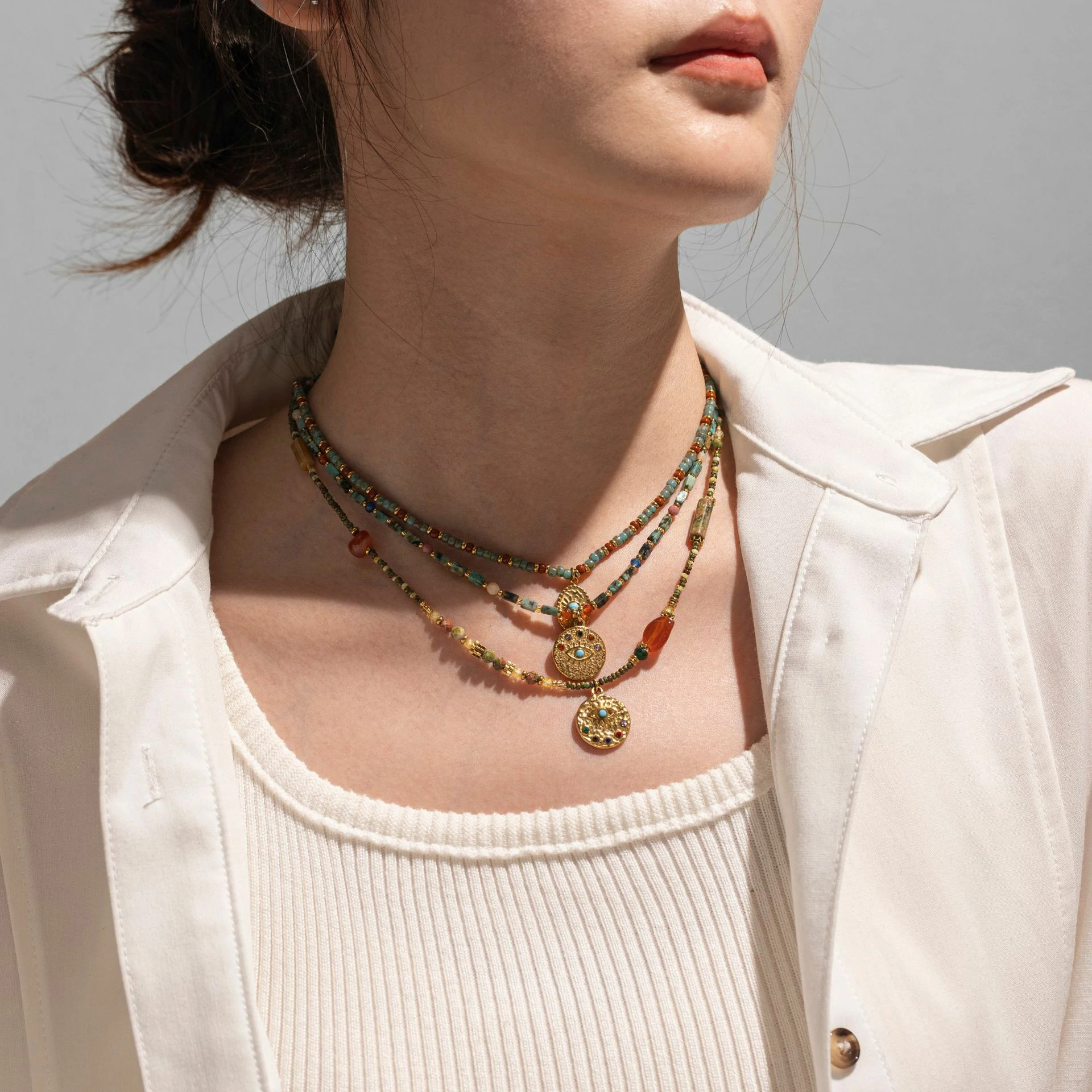 livke-minimalist-zirconia-sweater-necklace-layering Woman wearing LIVKE cubic zirconia sweater necklace with knitwear and blazer, showcasing versatile minimalist jewelry for work and casual outfits