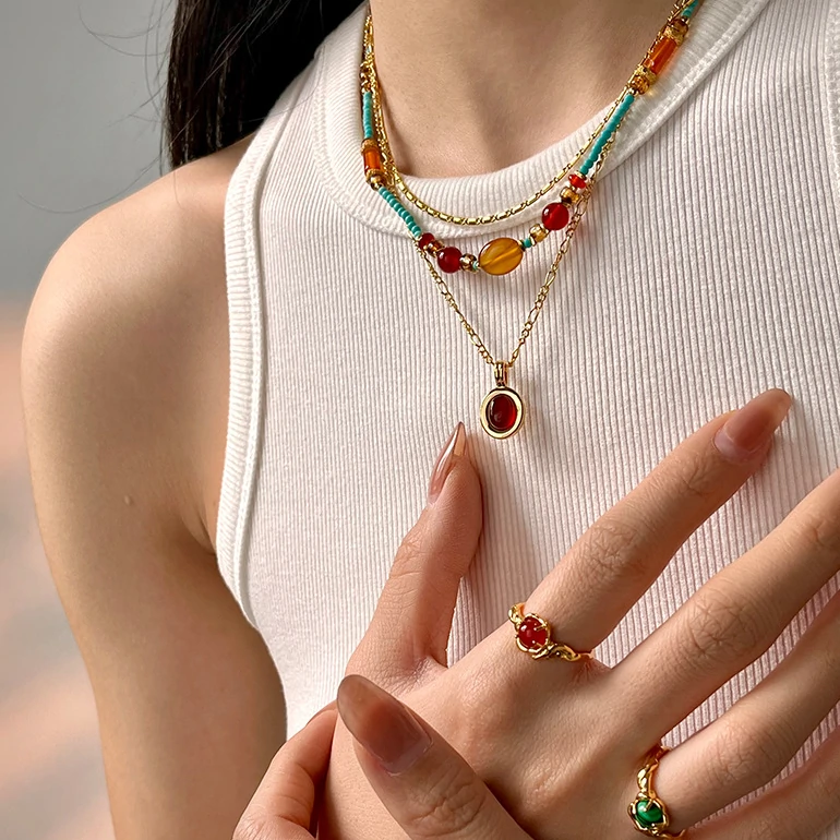 Asian model wearing LIVKE beaded necklace with cheongsam and tailored blazer, blending traditional Chinese elements with modern minimalist style