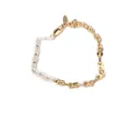 Gold-Plated Moonlight Pearl Bracelet 11 Stylist mixing LIVKE gold chain modules with baroque pearls on antique velvet tray in Paris concept store