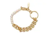 Gold-Plated Moonlight Pearl Bracelet 1 Stylist mixing LIVKE gold chain modules with baroque pearls on antique velvet tray in Paris concept store