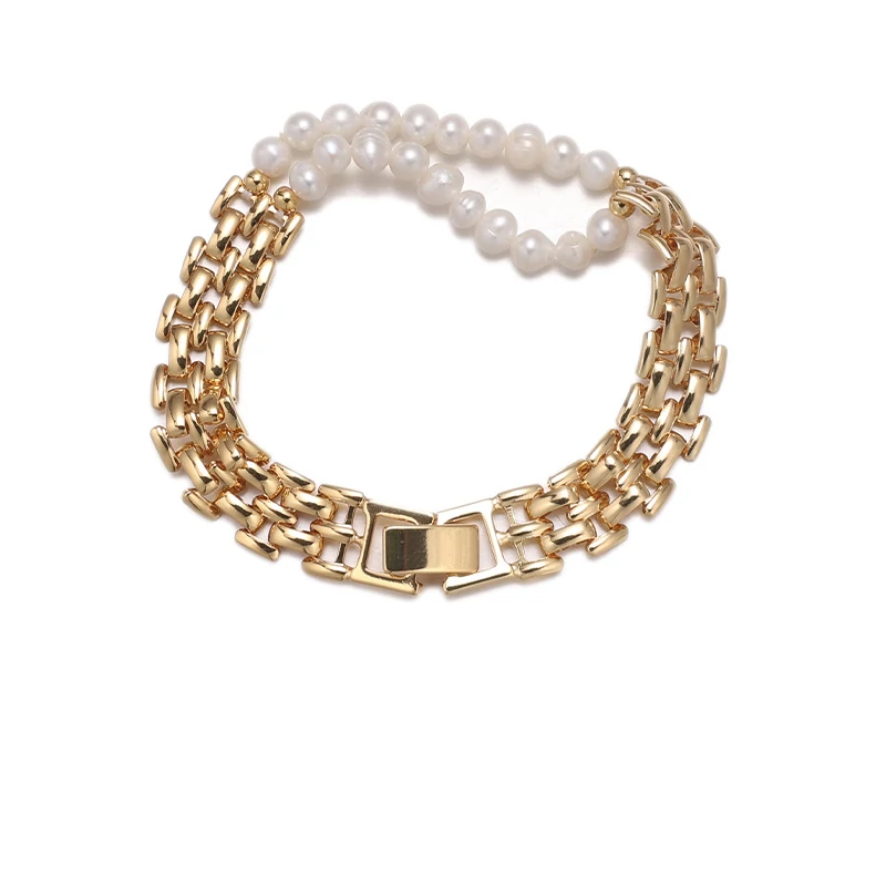 Stylist mixing LIVKE gold chain modules with baroque pearls on antique velvet tray in Paris concept store