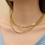 Natural Freshwater Pearl & Green Beaded Necklace 2 Woman wearing LIVKE pearl and green beaded necklace with silk blouse, showcasing minimalist jewelry for work and evening events