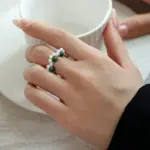 Adjustable Pearl & Natural Stone Wrap Ring 2 Hand wearing LIVKE adjustable wrap ring with pearls and green aventurine, layered with slim bands for boho chic style