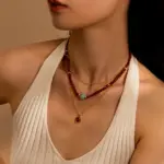 Red Agate Gold-Plated Necklace 3 LIVKE’s 18K gold-plated red agate necklace layered with delicate chains on a linen backdrop, styled for boho-chic elegance