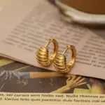 Spiral Threader Ear Cuffs 5 Contemporary art gallery visitor wearing LIVKE gold spiral ear cuffs with minimalist outfit, showcasing architectural jewelry styling